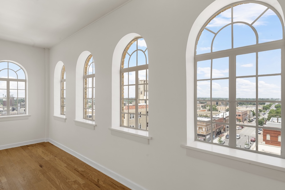 Hawn Tower Arched window view with wood flooring.