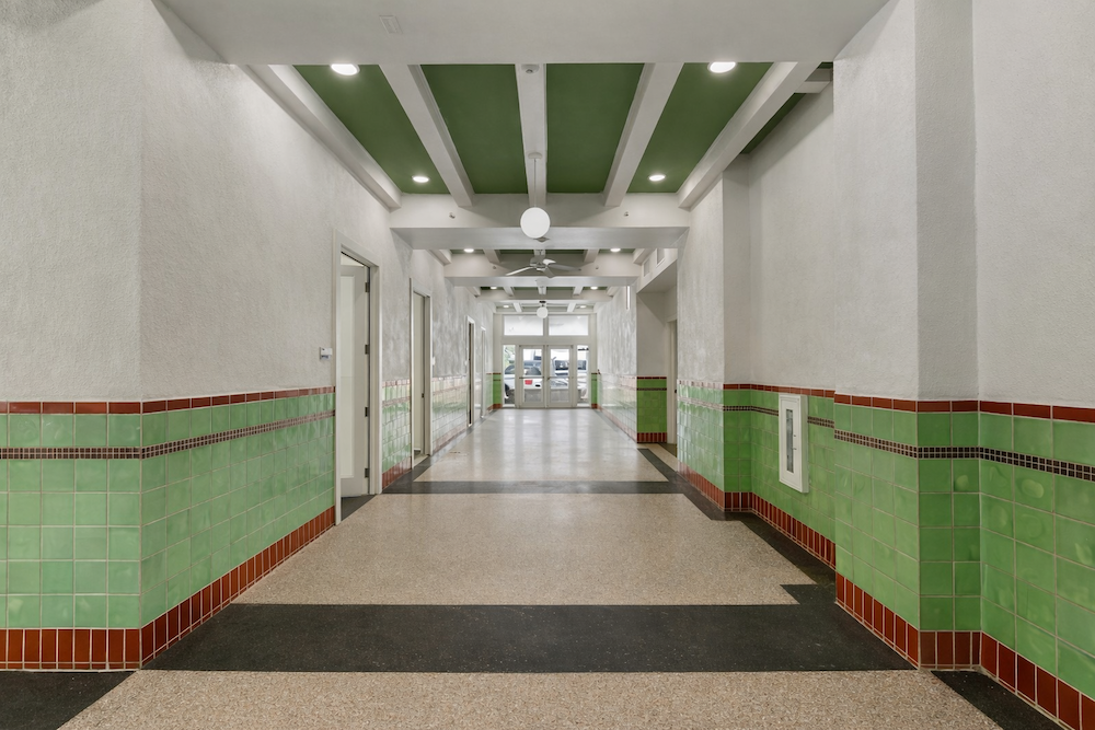 View of the tawny and green-tiled hallway leading outdoors of Hawn Tower.